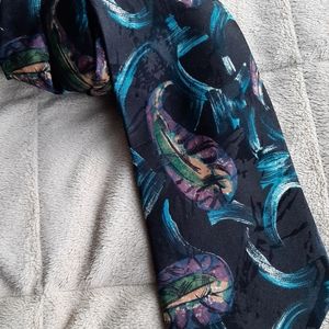 Beautiful black tie with modern design in blue with some pink, beige and…